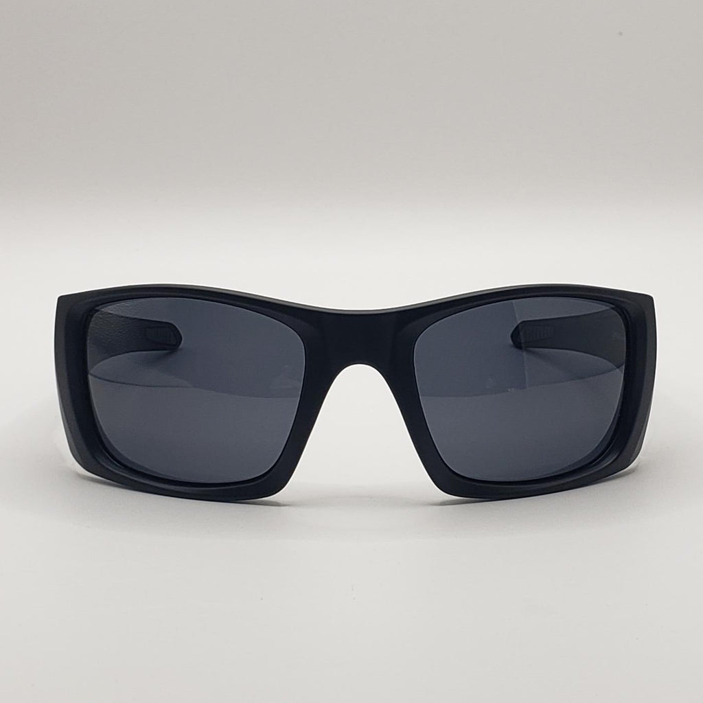 Black sunglasses with dark lenses on a light gray background