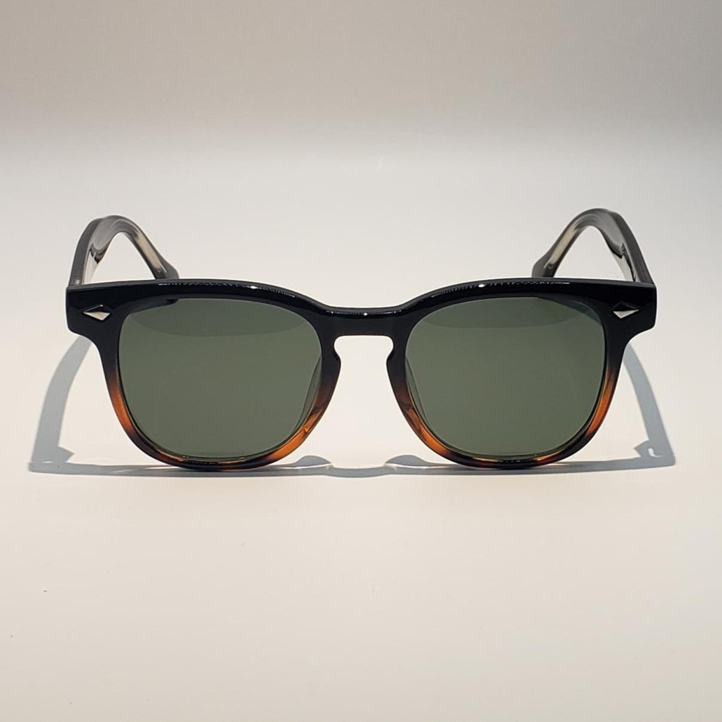 Sunglasses with tortoiseshell frame and green lenses on a white background